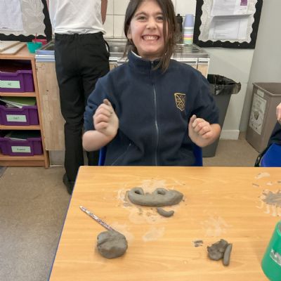 Children making clay lizards